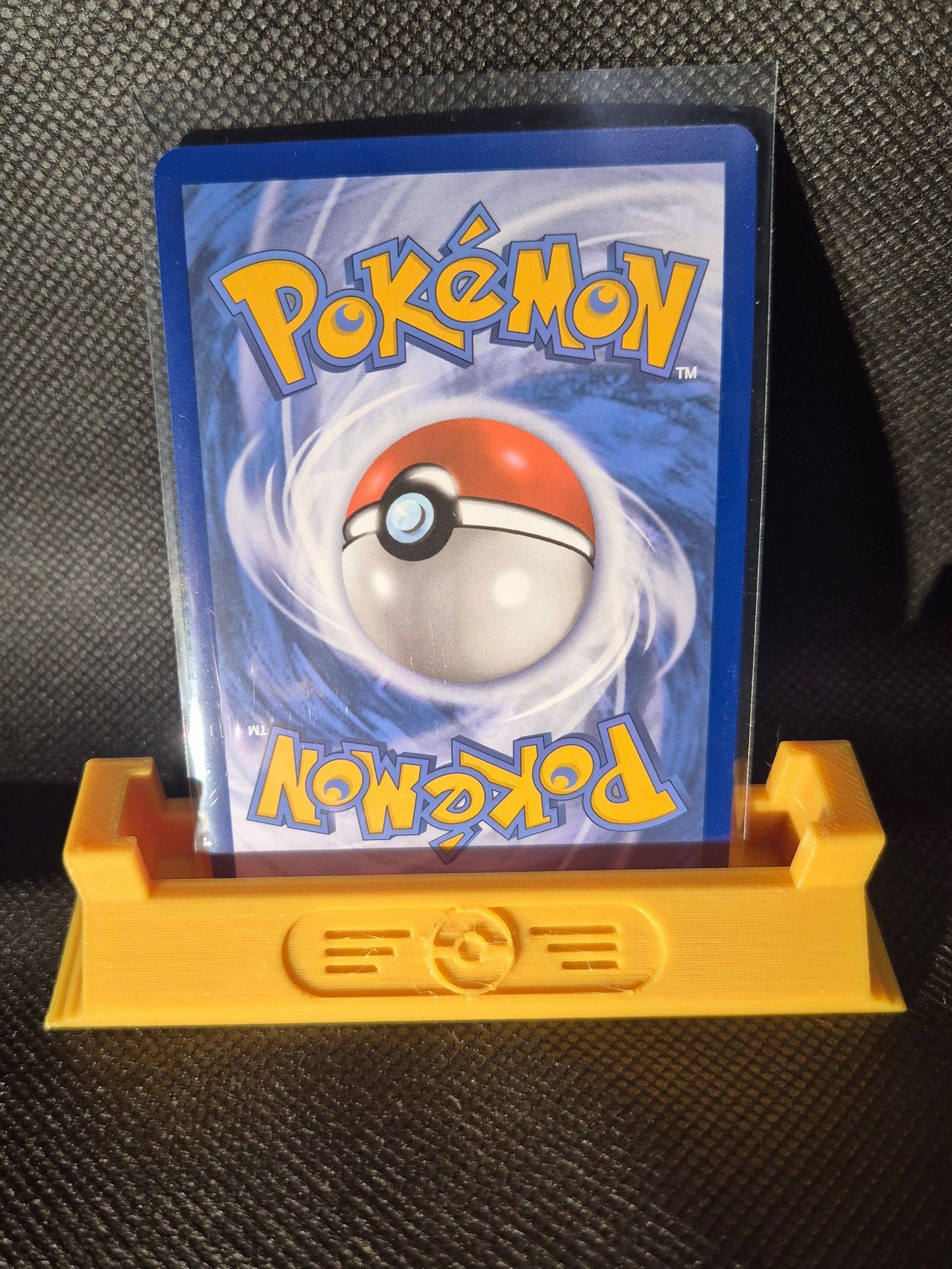 Pokémon Card in a holder on a black background